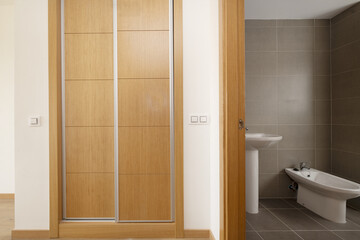 One bedroom suite bathroom with built-in wardrobe with sliding oak doors with aluminum edges