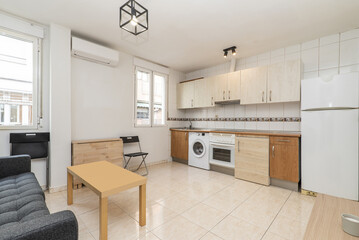 Kitchen with wooden cabinets arranged in a u-shape with a wooden and black marble countertop