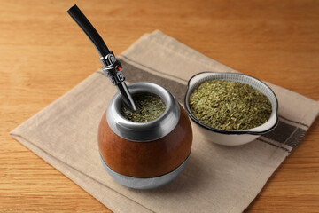 Calabash with mate tea and bombilla on wooden table
