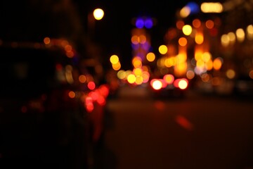 Blurred view of city street with lights at night. Bokeh effect