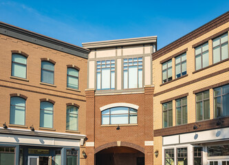 Obraz premium Beautiful view of building with arched windows. Windows with shutters on a vitage residential building facade