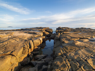 Fototapeta na wymiar Coastal Scene with Rocks at Dawn