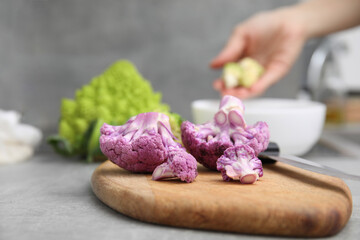 Fresh purple cauliflower on grey table, closeup