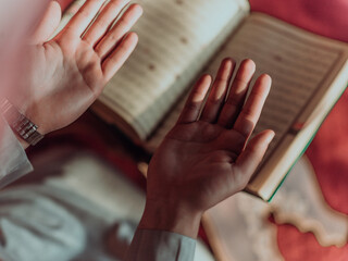 A Muslim reads the holy Islamic book Quraqn in a modern grand mosque during the Muslim holy month of Ranazan