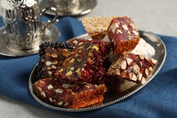 Tea and Turkish delight served in vintage tea set on grey table, closeup