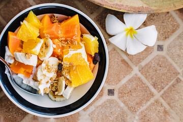 Healthy breakfast bowl with yogurt and tropic fruits