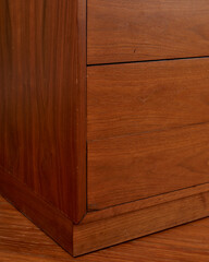 Walnut cabinet drawer. Close-up detail with wood grain.