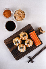 Takoyaki is Japanese Street Food containing with octopus, sausage or cheese. garnish with seaweed and katsuobushi