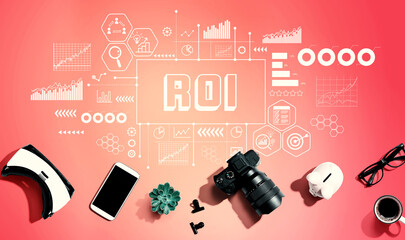 ROI theme with electronic gadgets and office supplies - flat lay