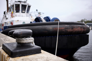 A large rope ensures a tug remains tied up at a wharf 