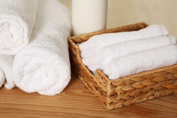 Fototapeta na wymiar Soft folded terry towels on wooden table, closeup