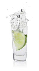 Fototapeta na wymiar Vodka splashing out of shot glass with lime on white background