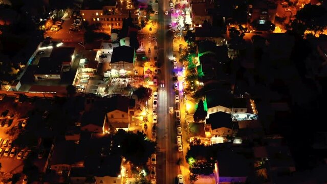 Aerial view hyper lapse of car traffic at night in a colorful streets.