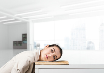 Bored business woman lying on desk