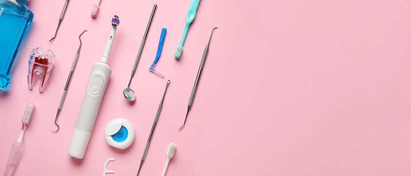 Brushes, floss and dental tools on pink background with space for text