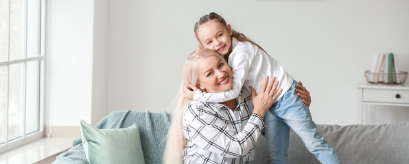 Fototapeta premium Little girl and grandmother hugging at home