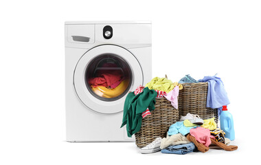 Modern washing machine with dirty clothes in laundry basket on white background