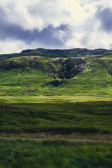 Beautiful nordic landscapes with mountains hills and waterfalls. Cloudy day