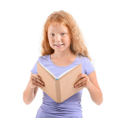 Little redhead girl with old book on white background