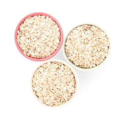 Bowls of raw oatmeal on white background