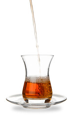 Pouring of Turkish tea into glass on white background