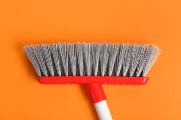 Broom for cleaning on color background, closeup