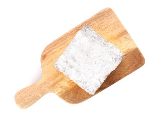 Cutting board with piece of cheese pie on white background