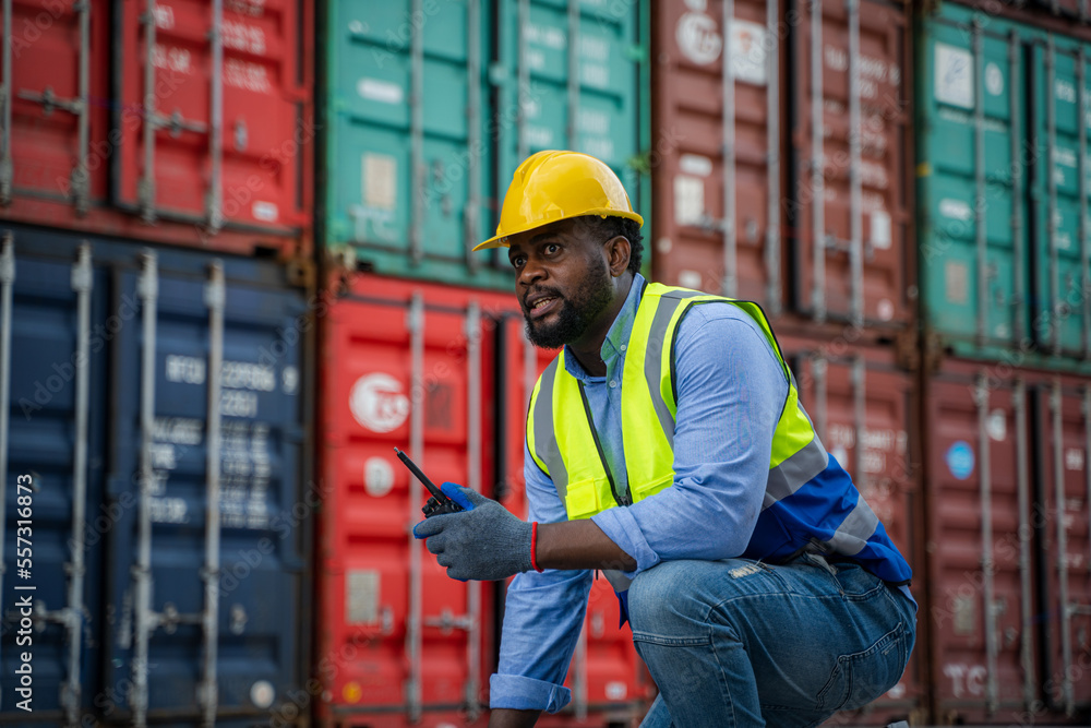 Poster engineer using walkie talkie checking stock into container for loading,international shipping logist