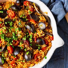 paella in a dish with herbs