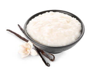 Bowl with delicious rice pudding and vanilla sticks on white background