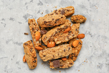 Tasty biscotti cookies, almond nuts and chocolate on grey table