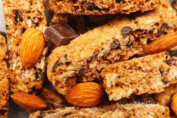 Tasty biscotti cookies, almond nuts and chocolate as background