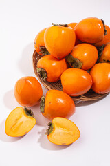 Delicious fresh persimmon fruit on table.