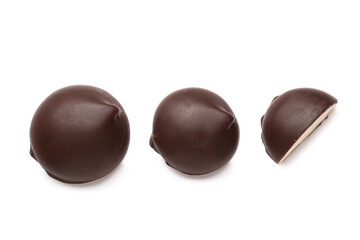 Chocolate bird's milk candies on white background
