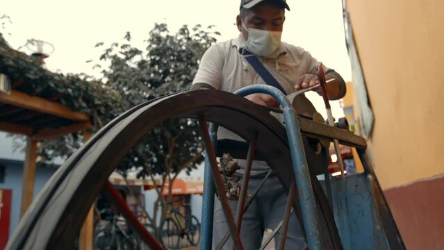 Low Shot Of Person Sharpening Knife On Big Wheel in Peru, Common Street Artisan in Latin America
