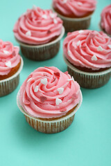 Tasty cupcakes for Valentine's Day on green background, closeup