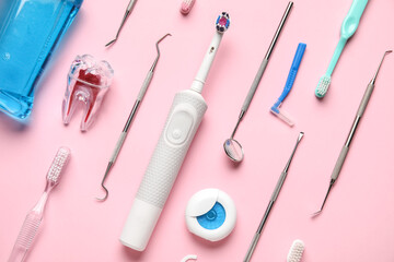 Dental tools with toothbrushes on pink background