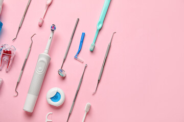 Dental tools with toothbrushes on pink background