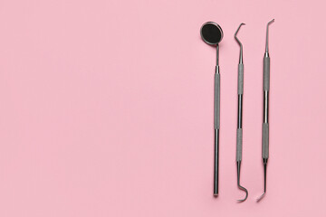 Dental tools on pink background