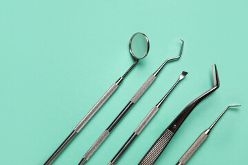 Dental tools on green background, closeup