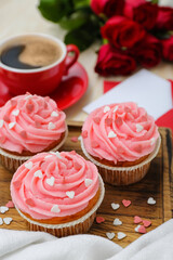 Tasty cupcakes for Valentine's Day on wooden board, closeup