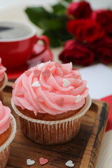 Tasty cupcake for Valentine's Day on wooden board, closeup