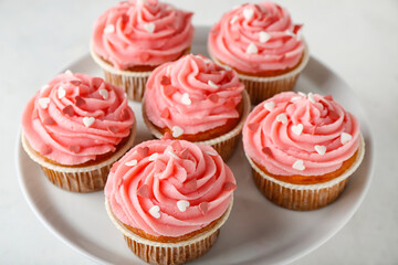Stand with tasty cupcakes for Valentine's Day on white background, closeup