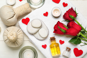 Obraz na płótnie Canvas Spa composition for Valentine's Day with stones, roses and candles on white wooden background
