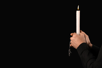 Jewish man with candle on dark background. International Holocaust Remembrance Day