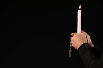 Jewish man with candle on dark background. International Holocaust Remembrance Day