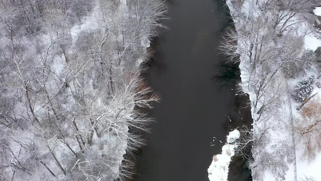 Overhead view of a river with snow covering the banks.