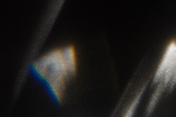Rainbow light effect from sun flares on black background, colorful glare and shine, light rays on...