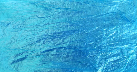 Fototapeta na wymiar blue plastic surface with rough and crumpled texture.