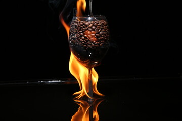 A goblet of coffee beans is in fire.